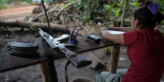 A member of the Revolutionary Armed Forces of Colombia (FARC) custodies the entrance to the Transitional Standardization Zone Jaime Pardo Leal in Colinas, Guaviare department, Colombia on June 14 , 2017. Colombia's Marxist FARC rebels handed in weapons last Tuesday in what were described as meaningful strides towards a deadline for a total surrender of arms on June 20. / AFP PHOTO / RAUL ARBOLEDA (Photo credit should read RAUL ARBOLEDA/AFP/Getty Images)