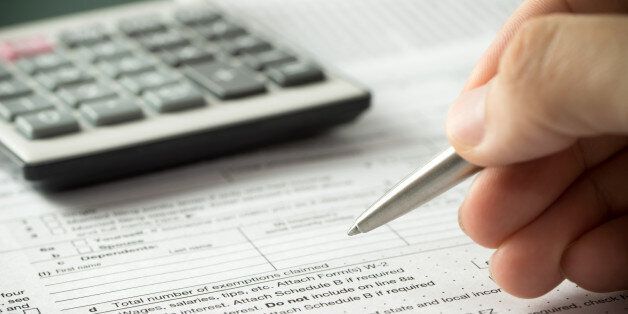 US individual income tax return form with pen and calculator