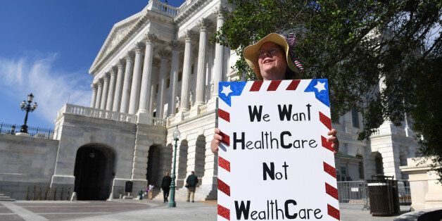 WASHINGTON, June 27, 2017 -- A woman protests against the new health care bill on Capitol in Washington D.C., the United States, June 27, 2017. The U.S. Senate draft bill to repeal and replace the Obamacare would increase the number of people without health insurance by 22 million by 2026, the nonpartisan Congressional Budget Office said Monday. (Xinhua/Yin Bogu via Getty Images)