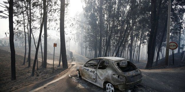 A burned car is seen in the aftermath of a forest fire near Pedrogao Grande, in central Portugal, June 18, 2017. REUTERS/Rafael Marchante