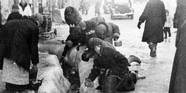 world war ll: the siege of leningrad, women taking water flowing from broken water mains. (Photo by: Sovfoto/UIG via Getty Images)