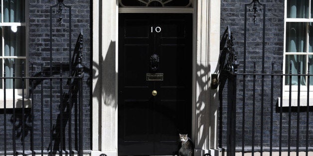 Larry, the Downing Street cat, a brown and white tabby rehomed from Battersea Dogs and Cats Home, sits outside number 10 Downing Street in London, U.K., on Tuesday, June 13, 2017. U.K. Prime Minister Theresa May bought herself a stay of execution by apologizing to her own lawmakers for the election debacle as she prepared to meet Northern Irelands Democratic Unionists to secure the votes needed to prop up her minority government. Photographer: Luke MacGregor/Bloomberg via Getty Images