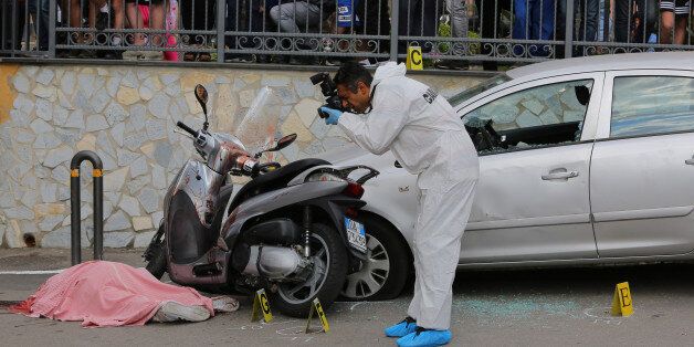 NAPLES, -, ITALY - 2017/05/26: Scientific police investigate on the place where they were killed while on board a scooter the 45-year-old and the 22-year-old whose name is both Carlo Nappello. The two men killed, uncle and grandson, are suspected to be affiliated the family camorra clan Lo Russo. Carabinieri and Scientific police investigate the place where two men, a 45-year-old and a 22-year-old, both of whose name is Carlo Nappello, were killed while on board a scooter. The two men killed,