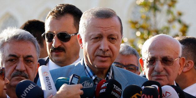Turkey's President Tayyip Erdogan talks to media after the Eid al-Fitr prayers in Istanbul, Turkey, June 25, 2017. REUTERS/Murad Sezer TPX IMAGES OF THE DAY