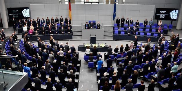 Members of the cabinet and members of the parliament stand in tribute to late former German Chancellor Helmut Kohl on June 22, 2017 at the Bundestag (lower house of parliament) in Berlin.Helmut Kohl, the former German chancellor who seized the chance to reunite his country after years of Cold War separation, died at the age of 87 on June 16, 2017. / AFP PHOTO / John MACDOUGALL (Photo credit should read JOHN MACDOUGALL/AFP/Getty Images)