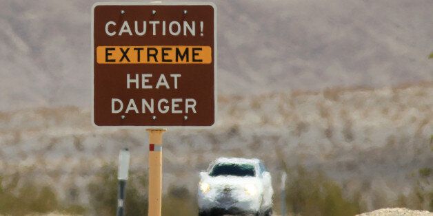 DEATH VALLEY NATIONAL PARK, CA JULY 14: Heat waves rise near a heat danger warning sign on the eve of the AdventurCORPS Badwater 135 ultra-marathon race on July 14, 2013 in Death Valley National Park, California. Billed as the toughest footrace in the world, the 36th annual Badwater 135 starts at Badwater Basin in Death Valley, 280 feet below sea level, where athletes begin a 135-mile non-stop run over three mountain ranges in extreme mid-summer desert heat to finish at 8,350-foot near Mount Whitney for a total cumulative vertical ascent of 13,000 feet. July 10 marked the 100-year anniversary of the all-time hottest world record temperature of 134 degrees, set in Death Valley where the average high in July is 116. A total of 96 competitors from 22 nations are attempting the run which equals about five back-to-back marathons. Previous winners have completed all 135 miles in slightly less than 24 hours. (Photo by David McNew/Getty Images)