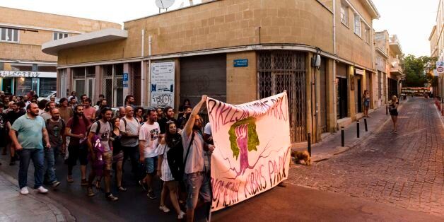 Turkish-Cypriot and Greek-Cypriot protestors take part in a demonstration calling for the unification of the Mediterranean island on June 28, 2017 in Nicosia. / AFP PHOTO / Iakovos Hatzistavrou (Photo credit should read IAKOVOS HATZISTAVROU/AFP/Getty Images)