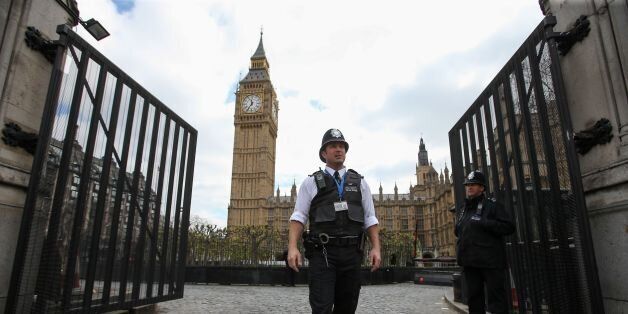 British police officers stand on duty alongside a set of temporary gates installed at the Carriage Gates entrance to the Houses of Parliament, within the Palace of Westminster, in central London on April 12, 2017. / AFP PHOTO / Daniel LEAL-OLIVAS (Photo credit should read DANIEL LEAL-OLIVAS/AFP/Getty Images)
