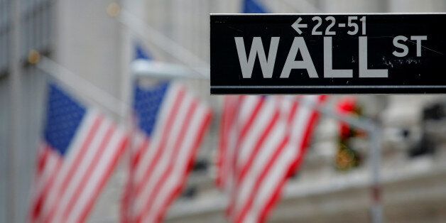 A street sign for Wall Street is seen outside the New York Stock Exchange (NYSE) in Manhattan, New York City, U.S. December 28, 2016. REUTERS/Andrew Kelly