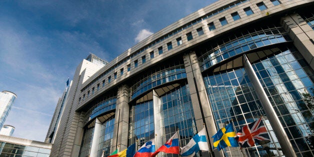 European Parliament in Brussels and a row of EU member states flags.