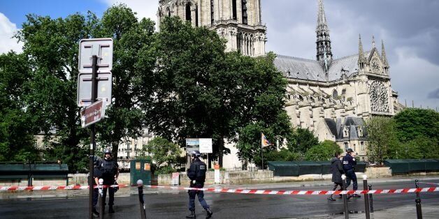 French police officials gather at a cordonned-off area at Notre-Dame Cathederal in Paris on June 6, 2017. A French police officer has shot and injured a man who attacked him with a hammer outside Paris's Notre-Dame cathedral authorities said. Police sealed off the area in front of the cathedral, where the attacker lay injured on the ground. / AFP PHOTO / Martin BUREAU (Photo credit should read MARTIN BUREAU/AFP/Getty Images)