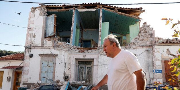A man walks past a damaged building at the village of Vrissa on the Greek island of Lesbos, Greece, after a strong earthquake shook the eastern Aegean, June 12, 2017. REUTERS/Giorgos Moutafis