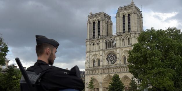 A French gendarme holds his helmet as he stands on a bridge near the entrance of Notre-Dame cathedral in Paris on June 6, 2017. Anti-terrorist prosecutors have opened a probe after police shot and injured a man who had tried to attack an officer with a hammer outside Notre Dame cathedral. The officer was slightly injured in the attack outside the world-famous landmark in central Paris. One of his colleagues responded by shooting him, wounding the attacker, whose motives were not immediately known, according to a police source. / AFP PHOTO / bertrand GUAY (Photo credit should read BERTRAND GUAY/AFP/Getty Images)