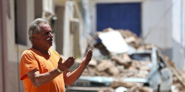 LESBOS, GREECE - JUNE 13 : A man gestures near the wreckages of buildings after the 6,2 magnitude earthquake hit Vrisa village of Lesbos in Greece on June 13, 2017. (Photo by Ali Atmaca/Anadolu Agency/Getty Images)