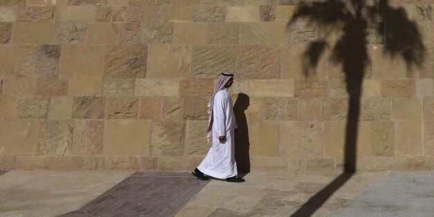 A pedestrian walks along the sidewalk and past the shadow of a palm tree at the King Abdullah Financial District (KAFD) in Riyadh, Saudi Arabia, on Thursday, Dec. 1, 2016. The King Abdullah Financial District, known as the KAFD and about 70 percent complete, has been beset by construction delays since work began in the Saudi capital in 2006. Photographer: Simon Dawson/Bloomberg via Getty Images