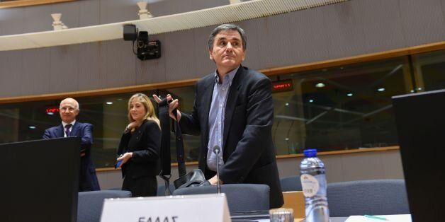Greek Finance Minister Euclid Tsakalotos (C) arrives to attend an Eurogroup meeting at the EU headquarters in Brussels on February 20, 2017. / AFP / JOHN THYS (Photo credit should read JOHN THYS/AFP/Getty Images)