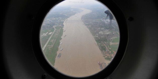 The Yangon river is seen from the window of a Thai military plane May 7, 2008. Military helicopters dropped food and water on Wednesday to the cyclone-stricken people of Myanmar's Irrawaddy delta, where entire villages have been washed away and one million people left homeless, officials said. Nearly 22,500 people were killed and 41,000 are still missing after Cyclone Nargis ripped through the delta, Asia's most devastating cyclone since 1991 when a storm killed 143,000 in neighbouring Bangladesh. REUTERS/Sukree Sukplang (MYANMAR)