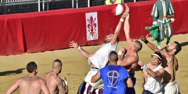 FLORENCE, ITALY - JUNE 11: Players take part in a game of the Calcio Storico Fiorentino ('Historic Florentine Football') match between Santa Croce (Blue Team) and Saint Spirit (White team) during the Historic Florentine Football Event at Piazza Santa Croce on June 11, 2017 in Florence, Italy. (Photo by Carlo Bressan/Anadolu Agency/Getty Images)