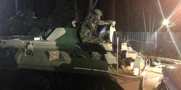 MOSCOW REGION, RUSSIA - JUNE 10, 2017: Military hardware seen outside the house in Pushkinskaya Street in the village of Kratovo in Ramensky District, where a man opened fire from a hunting rifle. The shooting has been going on for several hours; grenade explosions have also been heard. Four people have reportedly been killed, three left injured. Alexei Shtokal/TASS (Photo by Alexei Shtokal\TASS via Getty Images)