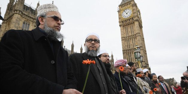 LONDON, ENGLAND - MARCH 29: Imams hold flowers as they gather on Westminster Bridge ahead of a vigil to remember the victims of last week's Westminster terrorist attack on March 29, 2017 in London, England. Faith Leaders head up a vigil including members of the public and police officers on Westminster Bridge exactly one week after Khalid Masood ploughed a hired car into people crossing Westminster Bridge, killing three. Masood gained entry to the grounds of the Houses of Parliament stabbing PC Keith Palmer to death before he was shot dead by armed police. (Photo by Carl Court/Getty Images)