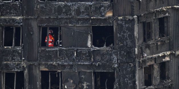 Emergency workers and police inspect inside the remains of Grenfell Tower, a residential tower block in west London which was gutted by fire, on June 16, 2017.Dozens of people are feared dead in the London tower block fire as emergency workers continued searching for bodies in the high-rise on Friday, warning they may never be able to identify some of the victims. / AFP PHOTO / Chris J Ratcliffe (Photo credit should read CHRIS J RATCLIFFE/AFP/Getty Images)