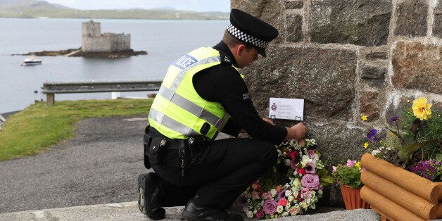 BARRA, UNITED KINGDOM - JUNE 5: Flowers are laid by an officer from Police Scotland on behalf of the Chief Constable of Greater Manchester Police and the Mayor of Greater Manchester outside the Church of Our Lady, Star of the Sea, in Castlebay on the island of Barra, ahead of the funeral of Manchester bomb victim Eilidh MacLeod. June 5, 2017 in Barra, Scotland. The 14-year-old was among 22 people who died in the terrorist attack at the Ariana Grande concert on Monday May 22. (Photo by Andrew M