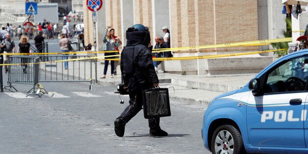 A police officer from the bomb disposal unit checks the area after an alarm near the Vatican, in Rome, Italy, May 23, 2017. REUTERS/Remo Casilli