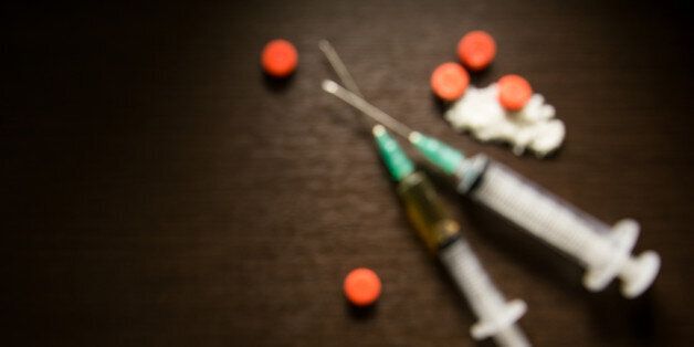 Background blur Drug syringe and cooked heroin