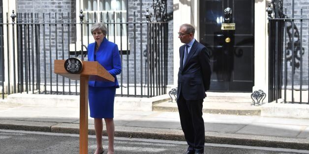 Britain's Prime Minister and leader of the Conservative Party Theresa May, (L), accompanied by her husband Philip, delivers a statement outside 10 Downing Street in central London on June 9, 2017 as results from a snap general election show the Conservatives have lost their majority.British Prime Minister Theresa May will on Friday seek to form a new government, resisting pressure to resign after losing her parliamentary majority ahead of crucial Brexit talks. May is set to meet the head of state Queen Elizabeth II and ask for permission to form a new government, according to her Downing Street office. / AFP PHOTO / Ben STANSALL (Photo credit should read BEN STANSALL/AFP/Getty Images)