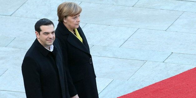 BERLIN, GERMANY - MARCH 23: Greek Prime Minister Alexis Tsipras (L) attends a military welcome ceremony with German Chancellor Angela Merkel (C) upon Tsipras' arrival for talks at the German federal Chancellery on March 23, 2015 in Berlin, Germany. The two leaders are meeting as relations between the Tsipras government and Germany have soured amidst contrary views between the two countries on how Greece can best work itself out of its current economic morass. (Photo by Adam Berry/Getty Images)