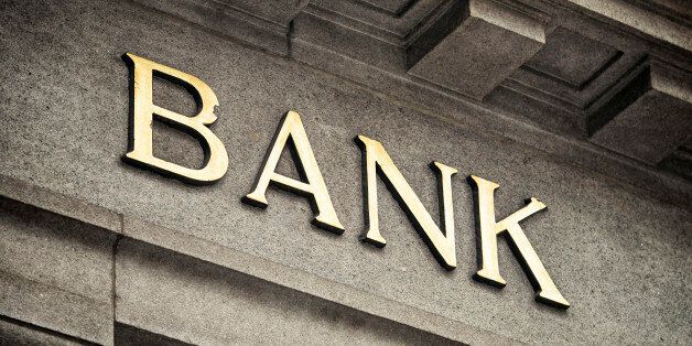 An old fashioned 'Bank' sign on a building exterior.