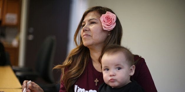 Mexican immigrant Maria Hernandez, 50, feeds her ten-month-old grandson Pablo at a Mother's Day celebration for immigrant mothers in Los Angeles, California, U.S., May 10, 2017. REUTERS/Lucy Nicholson