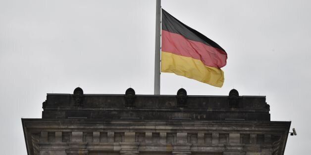 The German flag flies at halfmast at the Reichstag building that houses Germany's Bundestag lower house of parliament in Berlin, on May 24, 2017.At least 22 people died in Monday night's bombing attack on a Manchester pop concert, including an eight-year-old girl and several parents who had come to pick up their children. / AFP PHOTO / John MACDOUGALL (Photo credit should read JOHN MACDOUGALL/AFP/Getty Images)
