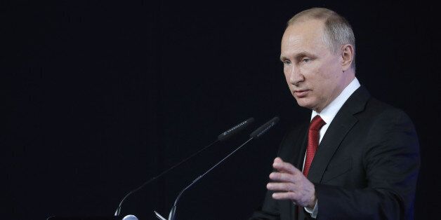 Russian President Vladimir Putin delivers a speech during a business roundtable session