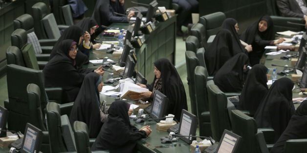 Iranian female MPs attend a parliament session presenting the proposed annual budget, on December 4, 2016, in Tehran. / AFP / ATTA KENARE (Photo credit should read ATTA KENARE/AFP/Getty Images)