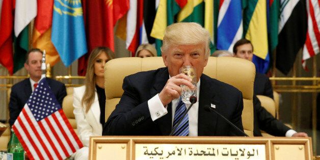 U.S. President Donald Trump drinks water before delivering a speech during Arab-Islamic-American Summit in Riyadh, Saudi Arabia May 21, 2017. REUTERS/Jonathan Ernst