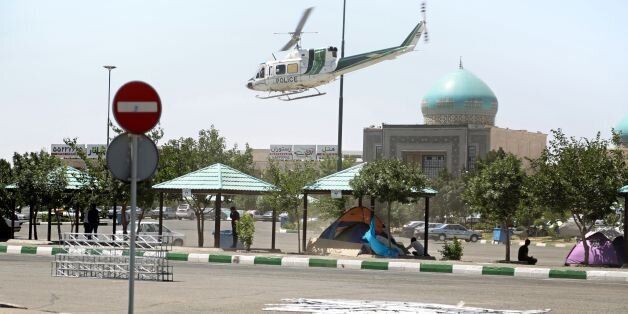 A picture taken on June 7, 2017, shows a police helicopter flying around outside the mausoleum of Ayatollah Ruhollah Khomeini in Tehran.Gunmen and suicide bombers stormed Iran's parliament and the shrine of its revolutionary leader, killing 12 people in the first attacks in the country claimed by the Islamic State group. / AFP PHOTO / MIZA NEWS / Hasan SHIRVANI (Photo credit should read HASAN SHIRVANI/AFP/Getty Images)