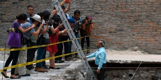 Mexican archaeologist Raul Barerra (R) gives an explanation during a tour by the archaeological site of the ancient Aztec temple of Ehecatl-Quetzalcoatl and ritual Ball Game recently discovered in downtown Mexico City, on June 7, 2017. / AFP PHOTO / ALFREDO ESTRELLA (Photo credit should read ALFREDO ESTRELLA/AFP/Getty Images)