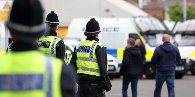 CARDIFF, WALES - APRIL 28: A group of police watch on as Newcastle United fans arrive before kick off of the Sky Bet Championship match between Cardiff City and Newcastle United at the Cardiff City Stadium on April 28, 2017 in Cardiff, Wales. (Photo by Athena Pictures/Getty Images)