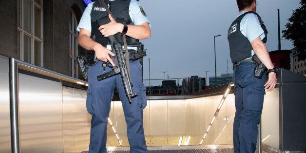 MUNICH, GERMANY - JULY 22: Armed police guard the entrance to Central train station underground station following a rampage shooting in the city on July 22, 2016 in Munich, Germany. Several people have been killed and an unknown number injured in a shooting at a shopping centre at the Olympia Einkaufzentrum (OEZ). (Photo by Johannes Simon/Getty Images)