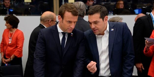 Greek Prime Minister Alexis Tsipras (R) speaks with French President Emmanuel Macron (L) during the NATO (North Atlantic Treaty Organization) summit at the NATO headquarters, in Brussels, on May 25, 2017. / AFP PHOTO / POOL / THIERRY CHARLIER (Photo credit should read THIERRY CHARLIER/AFP/Getty Images)