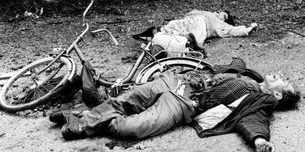The bodies of a man and woman lie along the street in the Sarajevo neighborhood of Alipasino Polje after they were hit by grenade shrapnel in this 1992 file photo. Genocide, siege and massacre are for many people in Bosnia more than just words on Radovan Karadzic's indictment. They represent years of suffering, dead friends and nightmares that will always haunt them. To match feature WARCRIMES-KARADZIC/LEGACY REUTERS/Danilo Krstanovic/Files (BOSNIA AND HERZEGOVINA)