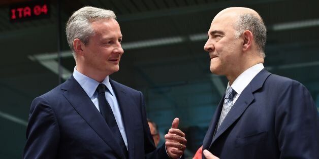 France's new Economy Minister Bruno Le Maire (L) speaks to European Commissioner for Economic and Financial Affairs, Taxation and Customs Pierre Moscovici during a Eurogroup finance ministers meeting on May 22, 2017 at the European Council in Brussels. / AFP PHOTO / EMMANUEL DUNAND (Photo credit should read EMMANUEL DUNAND/AFP/Getty Images)