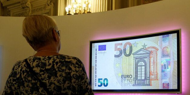 A visitor looks at a video with the new 50 Euro banknote at the Bank of Italy headquarters in Rome, Italy April 4, 2017. REUTERS/Remo Casilli