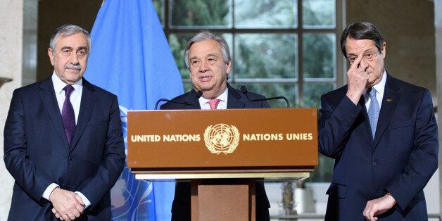 UN Secretary-General Antonio Guterres (C) speaks next to Greek Cypriot President Nicos Anastasiades (R) and Turkish Cypriot leader Mustafa Akinci during a press conference after the Conference on Cyprus, on the sidelines of the Cyprus Peace Talks, at the European headquarters of the United Nations in Geneva, Switzerland, January 12, 2017. REUTERS/Laurent Gillieron/Pool