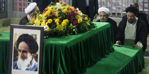 Iranian President-elect Hassan Rouhani (2nd R) pays his respects to the grave of the founder of the Islamic Republic Ayatollah Ruhollah Khomeini at his mausoleum in Tehran June 16, 2013. Reuters/Fars News/Seyed Hassan Mousavi (IRAN - Tags: POLITICS) ATTENTION EDITORS - THIS IMAGE WAS PROVIDED BY A THIRD PARTY. FOR EDITORIAL USE ONLY. NOT FOR SALE FOR MARKETING OR ADVERTISING CAMPAIGNS. THIS PICTURE IS DISTRIBUTED EXACTLY AS RECEIVED BY REUTERS, AS A SERVICE TO CLIENTS