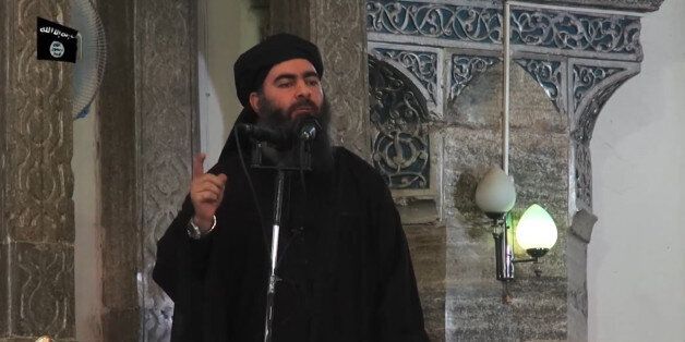 This July 5, 2014 photo shows an image grab taken from a propaganda video released by al-Furqan Media allegedly showing the leader of the Islamic State (IS) jihadist group, Abu Bakr al-Baghdadi, aka Caliph Ibrahim, adressing Muslim worshippers at a mosque in the militant-held northern Iraqi city of Mosul. Baghdadi, who on June 29 proclaimed a 'caliphate' straddling Syria and Iraq, purportedly ordered all Muslims to obey him in the video released on social media. In early 2014 the self-styled Islamic State entered the northern Syrian city of Raqqa, declaring it their capital and beginning a reign of terror marked by grisly public executions.Armed sharia police patrolled the streets as 'enemies' of the regime were crucified or decapitated, their severed heads impaled on spikes in the city square.Student Abdalaziz Alhamza and his friends decided to form 'Raqqa is Being Silently Slaughtered' (RBSS), a band of courageous citizen journalists who risk their lives to document IS atrocities. / AFP / - (Photo credit should read -/AFP/Getty Images)