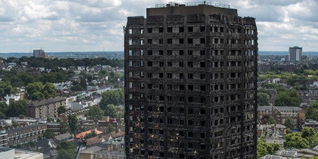 LONDON, ENGLAND - JUNE 15: Debris hangs from the blackened exterior of Grenfell Tower on June 15, 2017 in London, England. At least 17 people have been confirmed dead and dozens missing, after the 24 storey residential Grenfell Tower block in Latimer Road was engulfed in flames in the early hours of June 14. The number of fatalities are expected to rise. (Photo by Dan Kitwood/Getty Images)