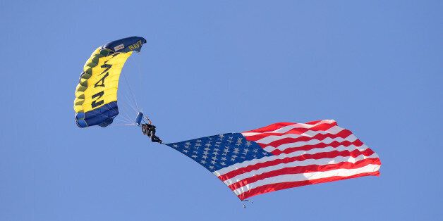 SAN DIEGO, CA - JULY 10: A member of the U.S. Navy Parachute Team, the Leap Frogs, holds an American Flag as he parachutes into the stadium prior to the SiriusXM All-Star Futures Game at PETCO Park on July 10, 2016 in San Diego, California. (Photo by Mark Cunningham/MLB Photos via Getty Images)