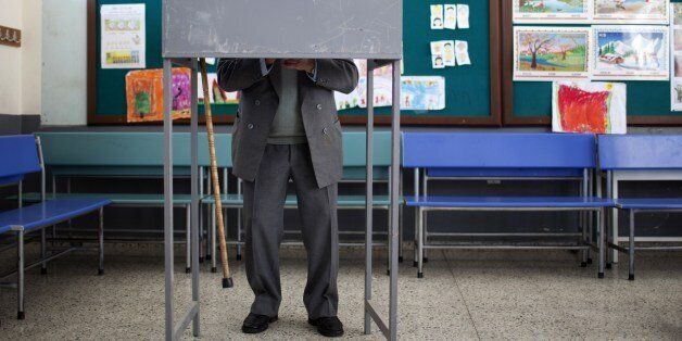 A Turkish Cypriot man stands behind the voting booth during the presidential election at a polling station on April 19, 2015, in the eastern port city of Famagusta in the self-proclaimed Turkish Republic of Northern Cyprus (TRNC). The tiny republic, which is only recognised by Turkey, heads to the polls to elect a new leader from seven candidates including incumbent Dervis Eroglu, Sibel Siber -- the sole woman candidate, the head of parliament and a former prime minister -- and independant Musta
